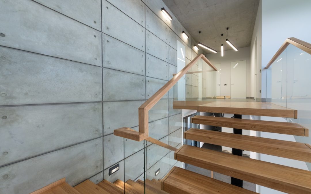 Wooden staircase with glass banister in house